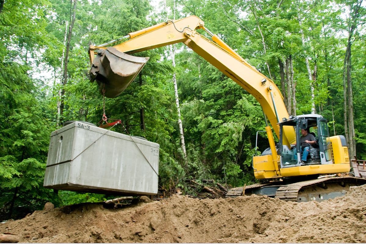 Septic system installation with excavation equipment on a residential property