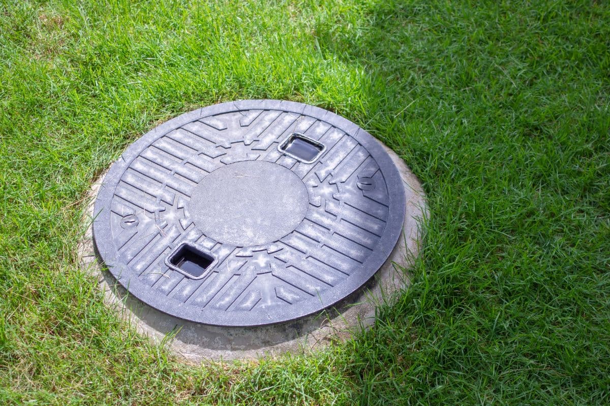 Homeowner locating septic tank in yard