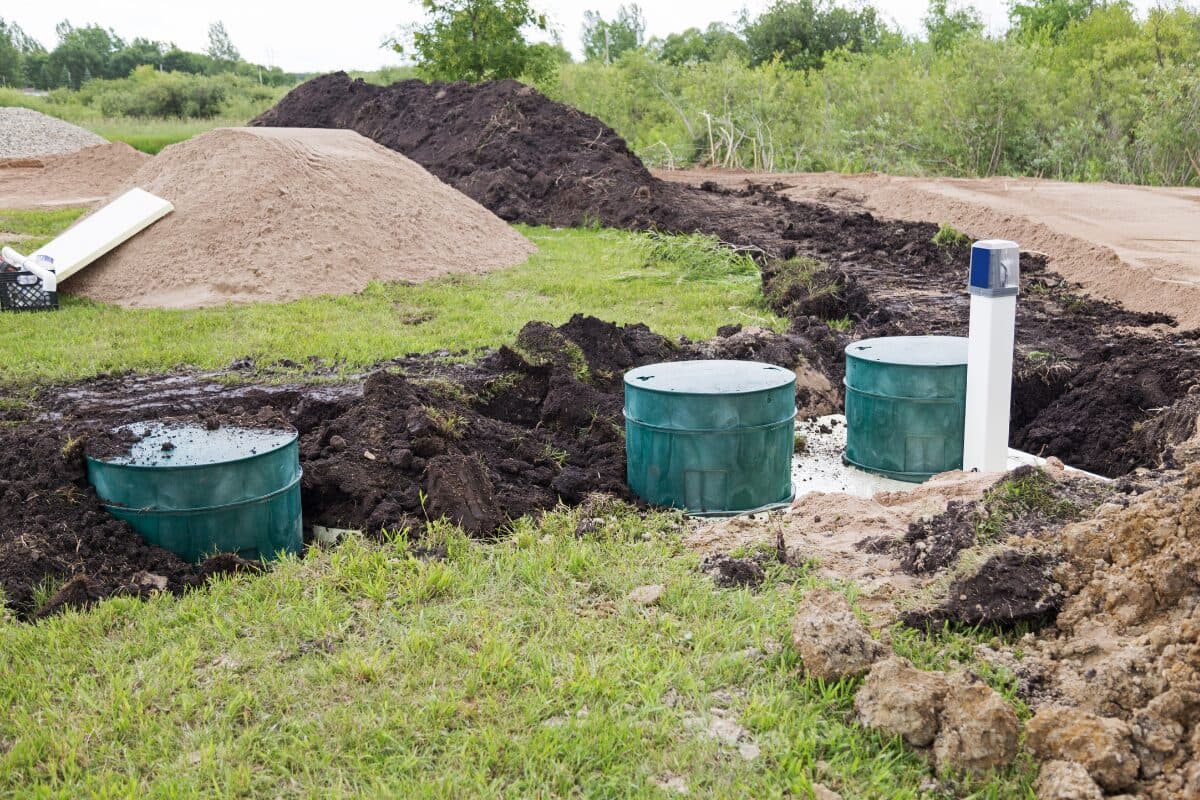 Old concrete septic tank being decommissioned in a backyard