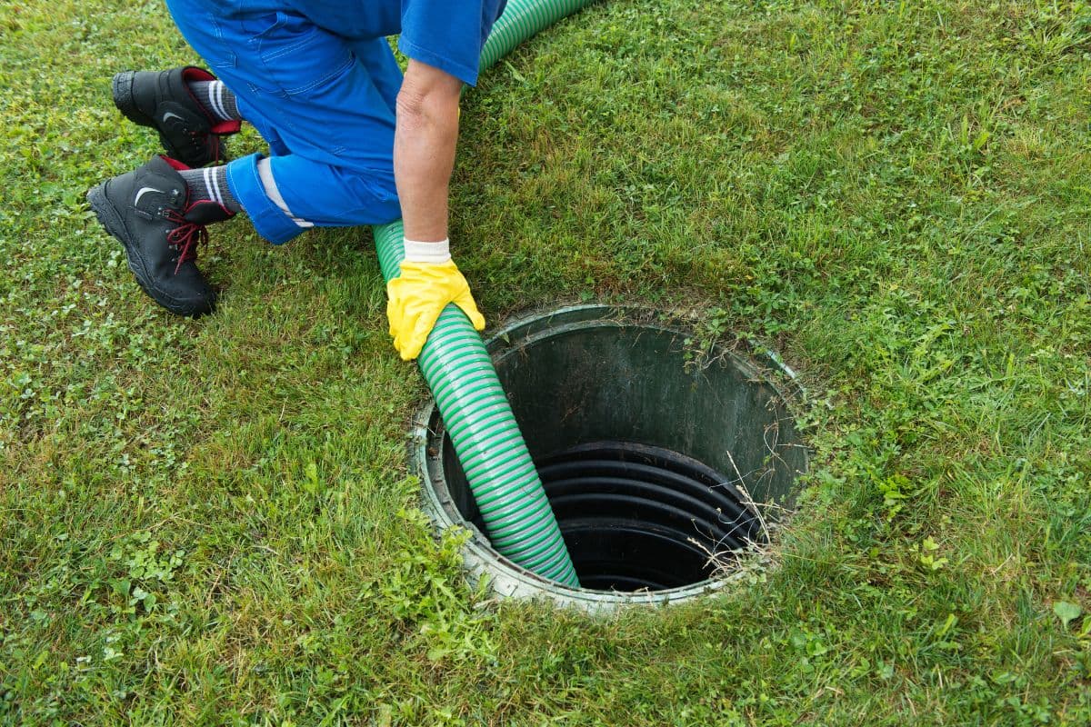 Septic tank pumping service truck at a residential property